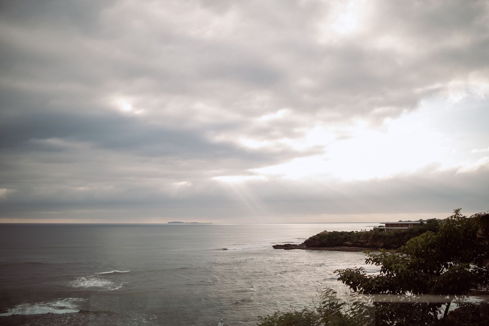 Rocky Punta Mita coastline with the ocean under a cloudy sunset sky