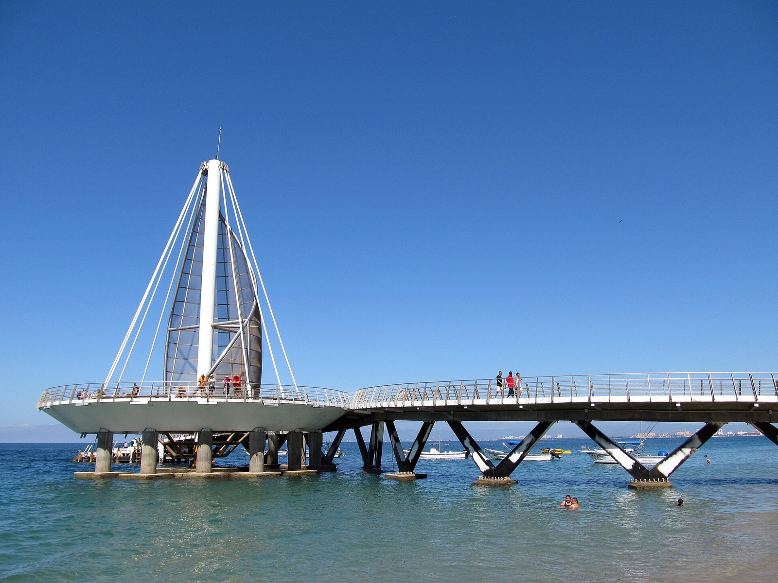 Los Muertos Pier in Puerto Vallarta, with its white sail-shaped structure over the water